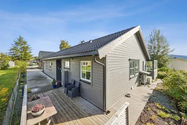 Sett fra en annen vinkel kommer boligens klassiske saltaksform og harmoniske proporsjoner tydelig frem. En tidløs arkitektur som vil glede i mange år fremover.