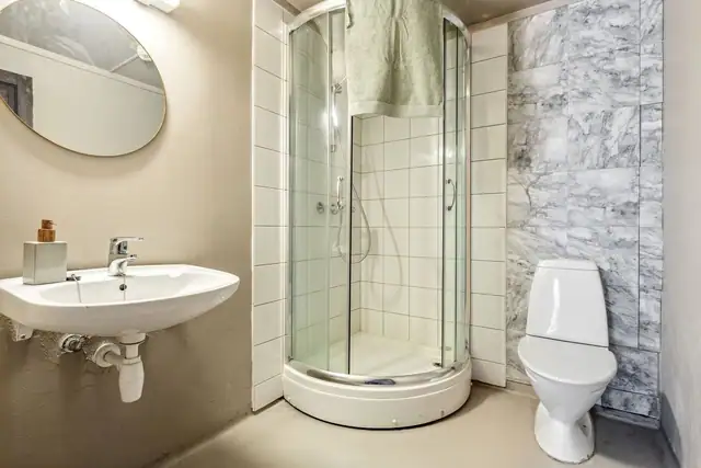 Badet er belagt med baderomsbelegg, mikrosement og fliser på vegger.